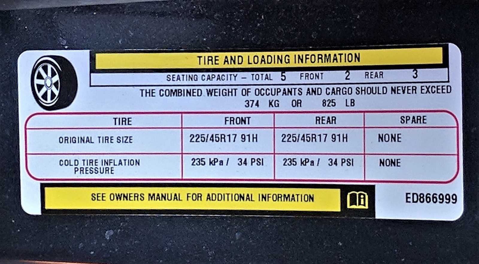 Yellow-and-white Tire and Loading Information label from a vehicle door jamb showing seating capacity, the combined weight of occupants and cargo limit, and cold tire pressures